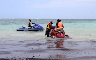 Jet-ski ride preparation on Diani Beach with turquoise water in the background.