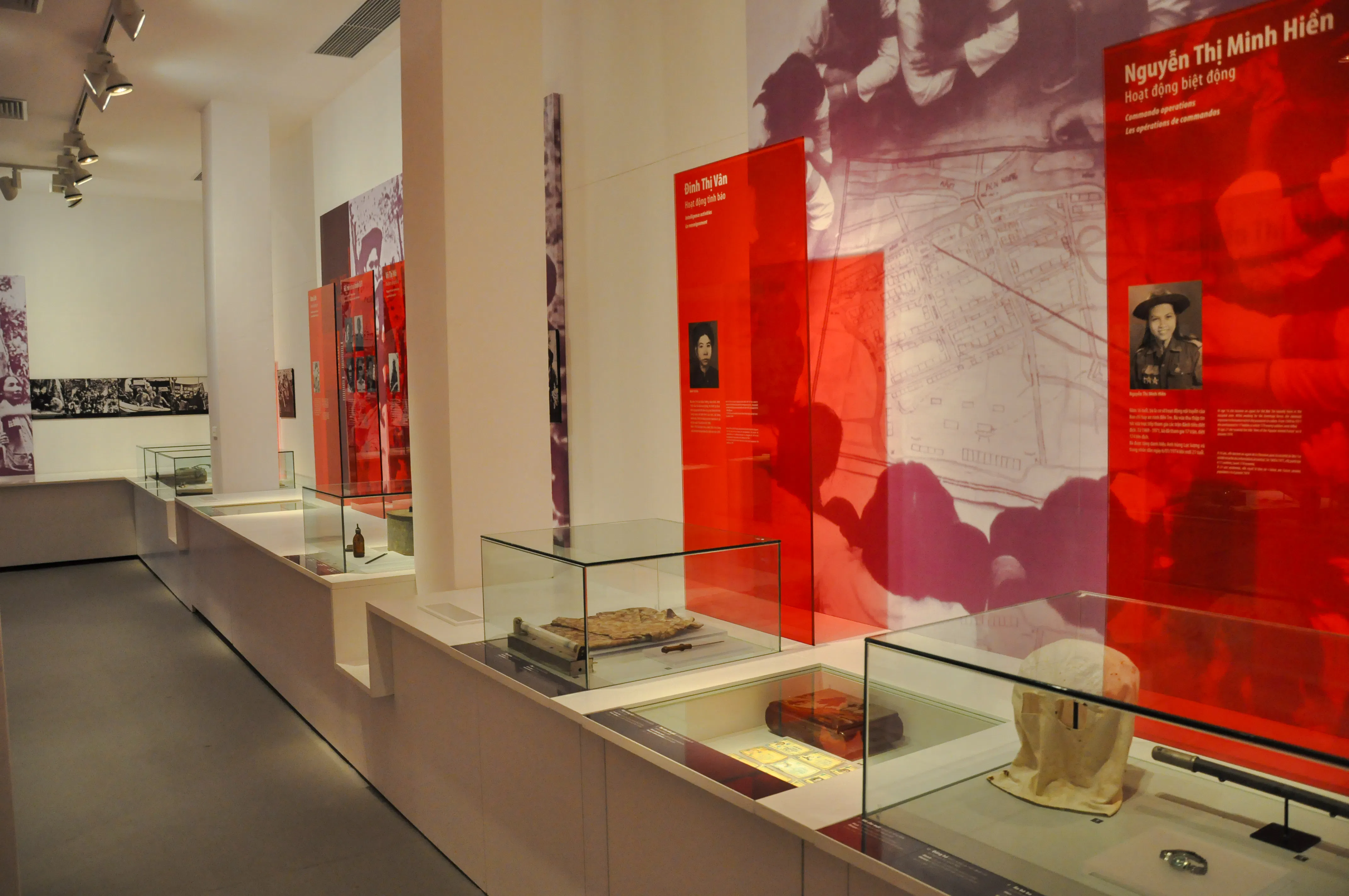 Exhibit displays at Vietnamese Women Museum, Hanoi, featuring historical artifacts and photographs.
