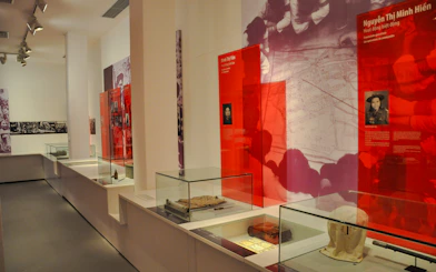 Exhibit displays at Vietnamese Women Museum, Hanoi, featuring historical artifacts and photographs.