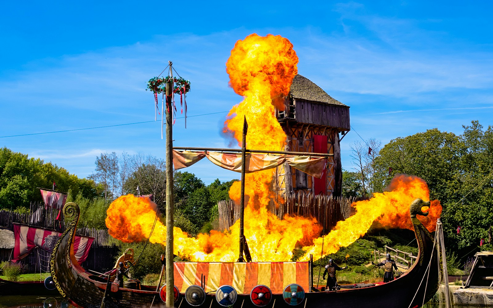 Viking reenactment at Puy du Fou, France, featuring warriors in traditional attire.
