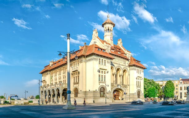 Archaeology museum building in Constanta, Romania with clear blue sky.