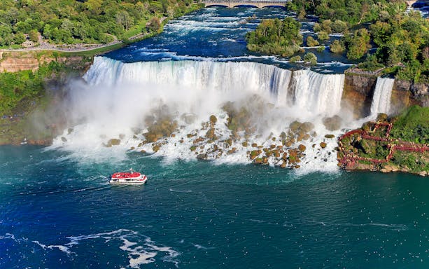 Aerial view of American and Bridal Veil Falls with tour boat on Niagara River.