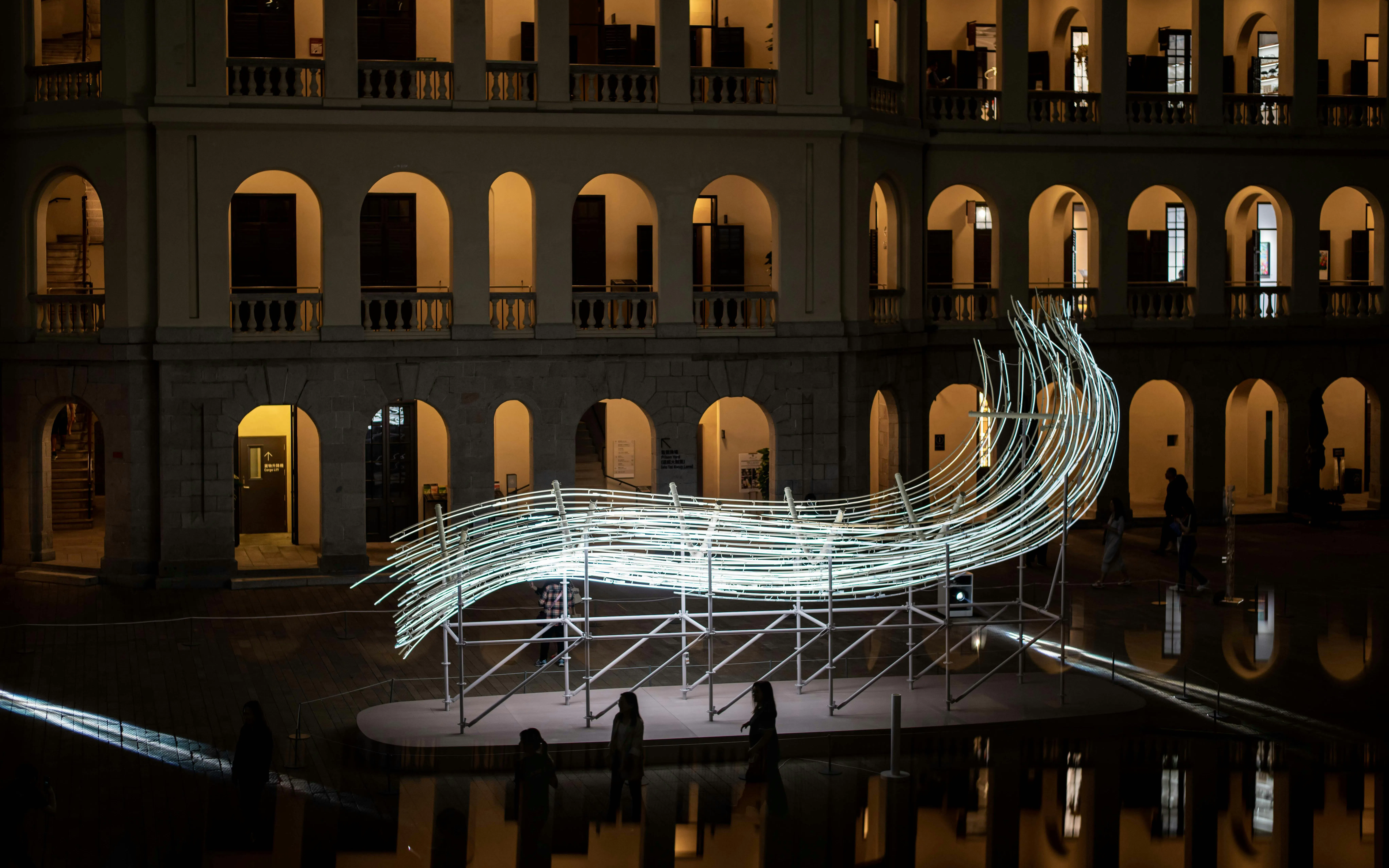 Amsterdam Light Festival installation with illuminated sculpture in front of historic building.