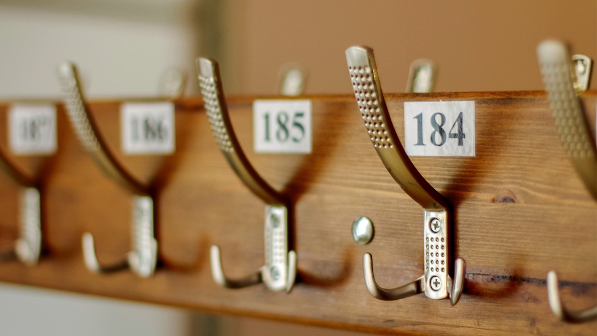 Cloakroom hooks with numbered tags at Borghese Gallery.