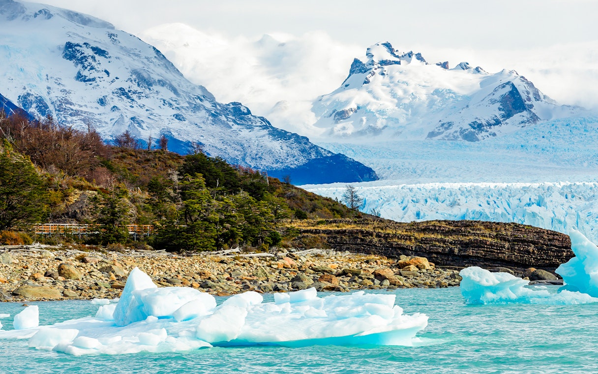 Spegazzini Glacier with icebergs in turquoise water, surrounded by snow-capped mountains in Patagonia.