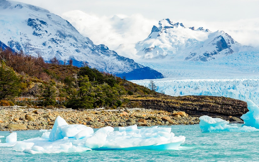 Spegazzini Glacier with icebergs in turquoise water, surrounded by snow-capped mountains in Patagonia.