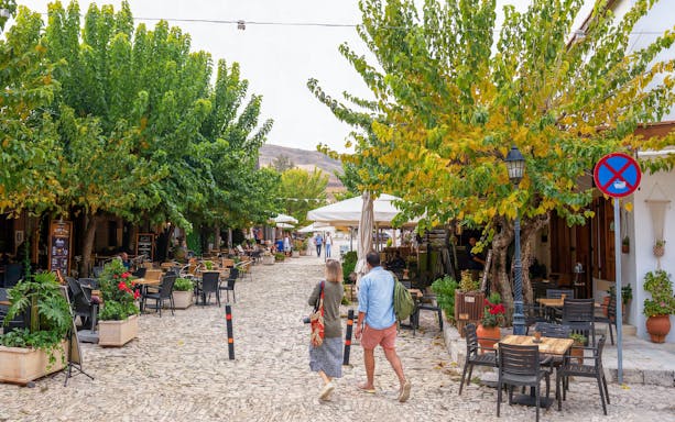 Pedestrian street with cafes and trees in Troodos village, Cyprus, part of the Paphos tour.