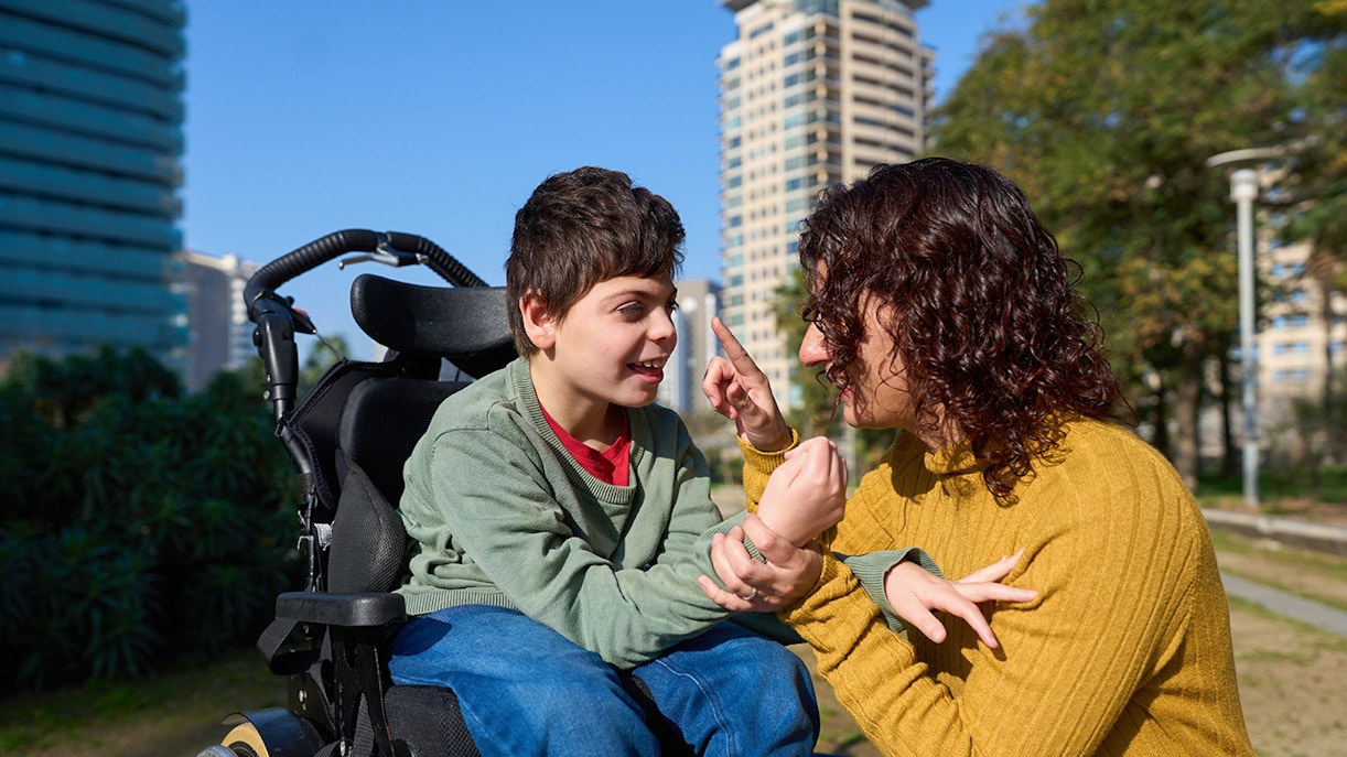 Disabled child learning with tutor