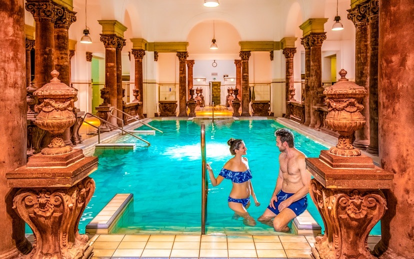 Indoor pool with ornate columns at Széchenyi Spa, Budapest.