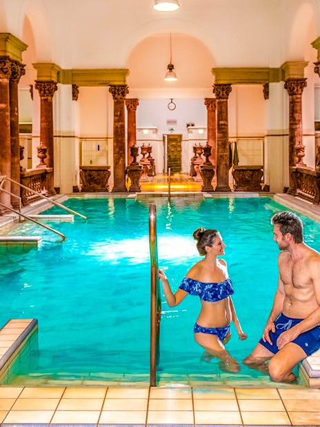 Indoor pool with ornate columns at Széchenyi Spa, Budapest.