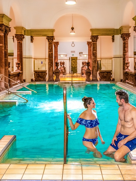 Indoor pool with ornate columns at Széchenyi Spa, Budapest.
