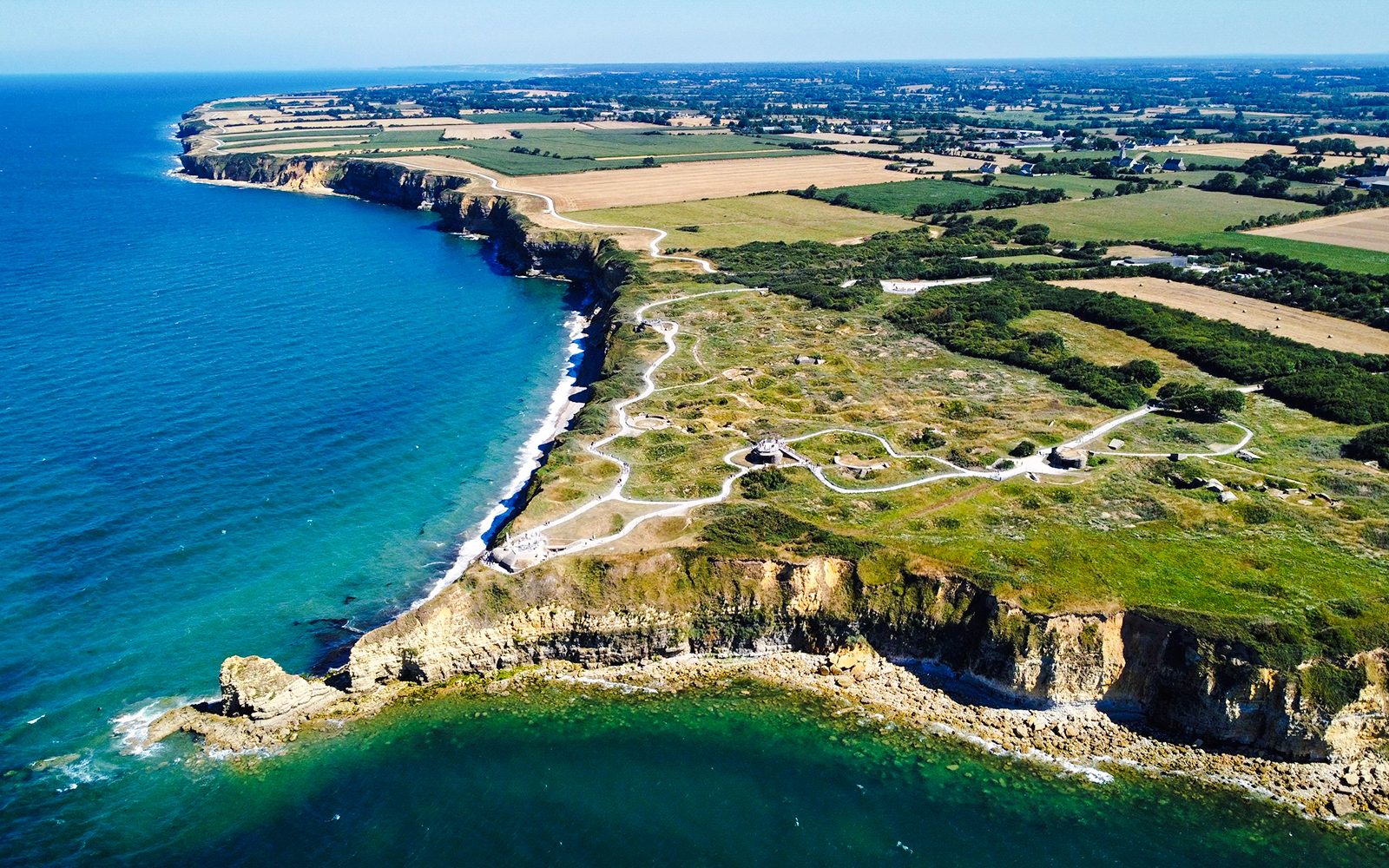 Aerial view of Pointe du Hoc cliffs and Ranger Monument, Normandy coastline.