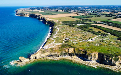 Aerial view of Pointe du Hoc cliffs and Ranger Monument, Normandy coastline.
