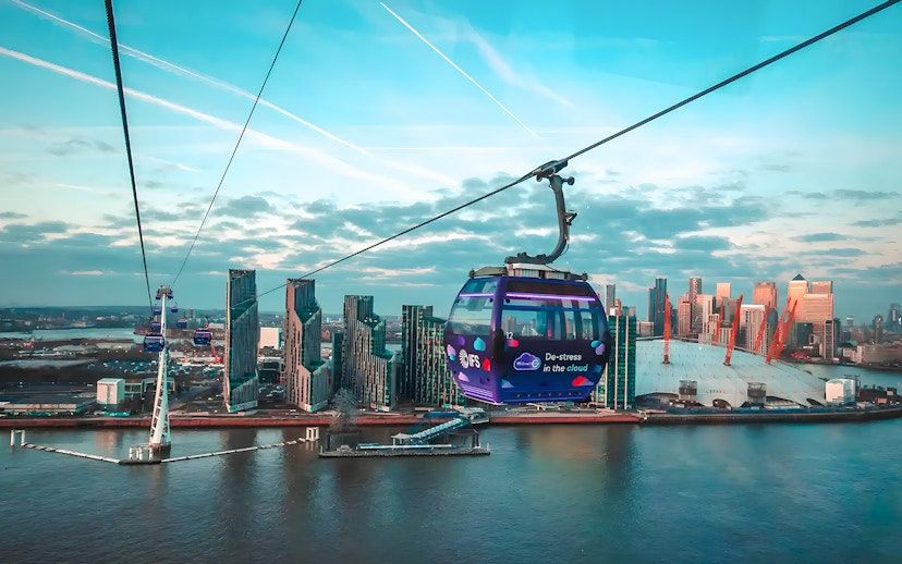 London IFS Cable Car over River Thames with city skyline in the background.