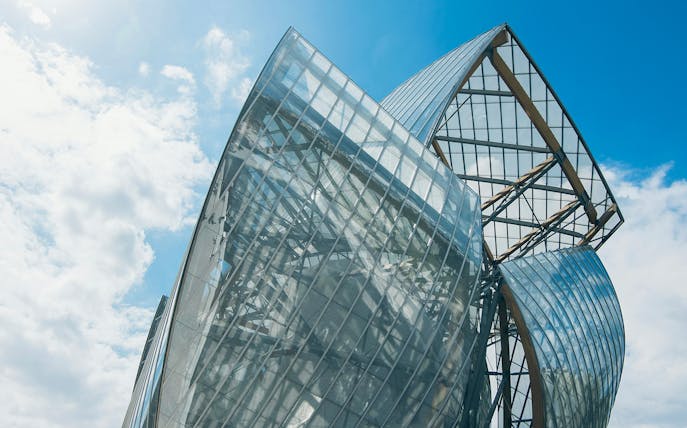 Fondation Louis Vuitton building with glass panels in Paris.