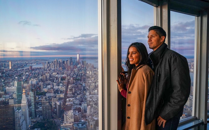 Couple enjoying New York City skyline view from observation deck with Go City pass.