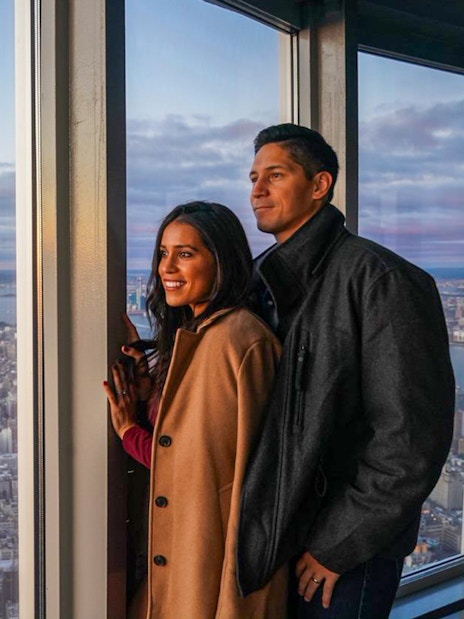 Couple enjoying New York City skyline view from observation deck with Go City pass.