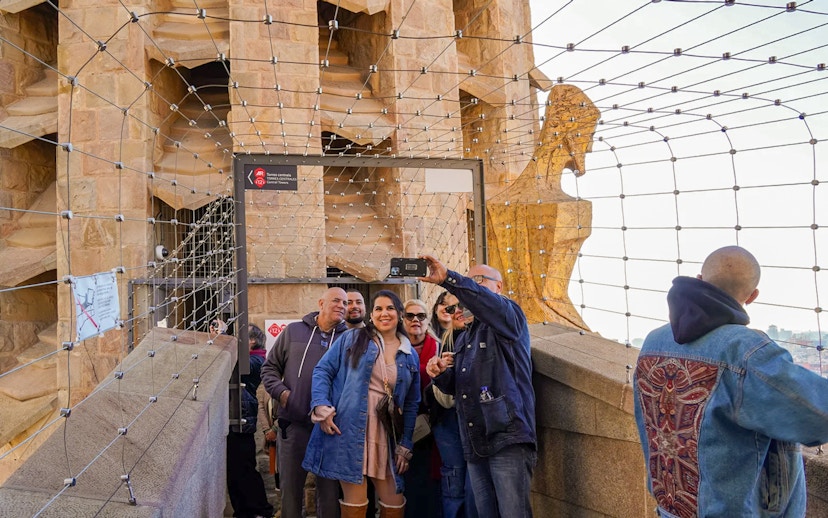 Tourists taking a selfie on Sagrada Familia tower in Barcelona.