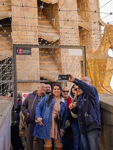 Tourists taking a selfie on Sagrada Familia tower in Barcelona.