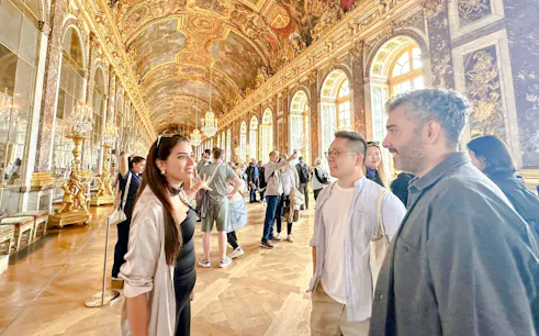 Visitors on a guided tour in the Hall of Mirrors, Palace of Versailles.