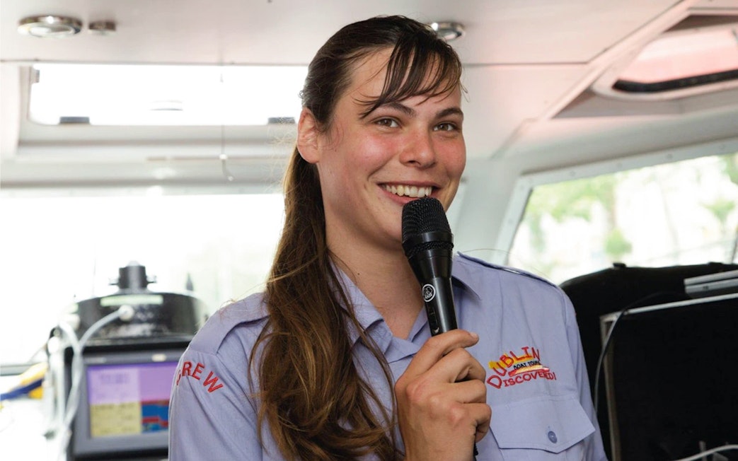 Guide speaking on Dublin River cruise boat.