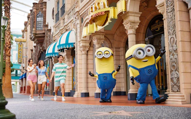 Visitors walking with Minion characters at Universal Studios Singapore.