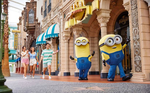 Visitors walking with Minion characters at Universal Studios Singapore.