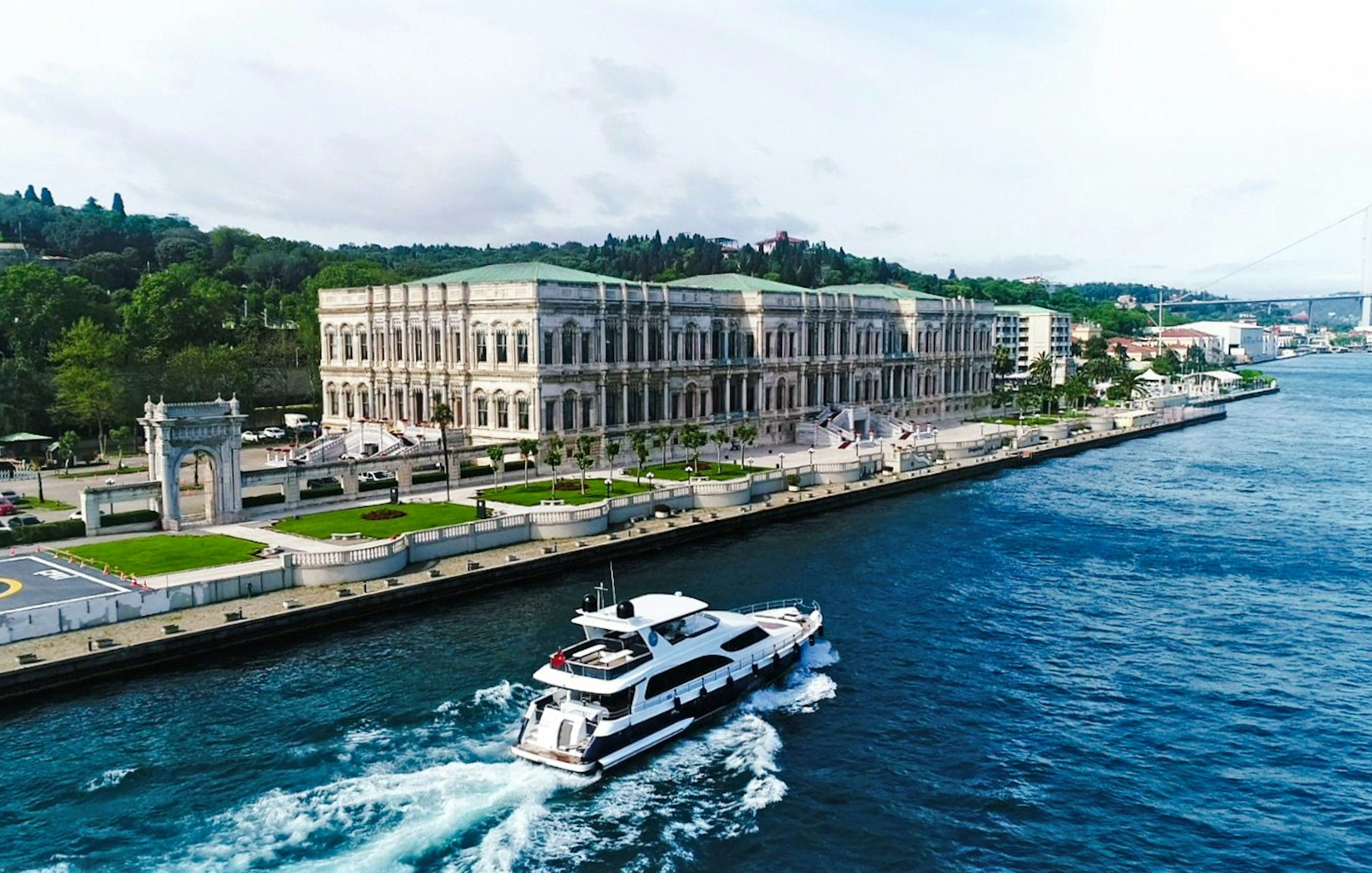 Yacht cruising past Çırağan Palace on the Bosphorus, Istanbul.