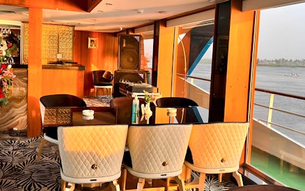 Dining area on a Nile dinner cruise ship in Cairo with river view.
