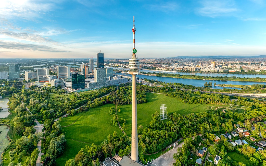 Danube Tower overlooking Vienna cityscape and green parkland, Austria.