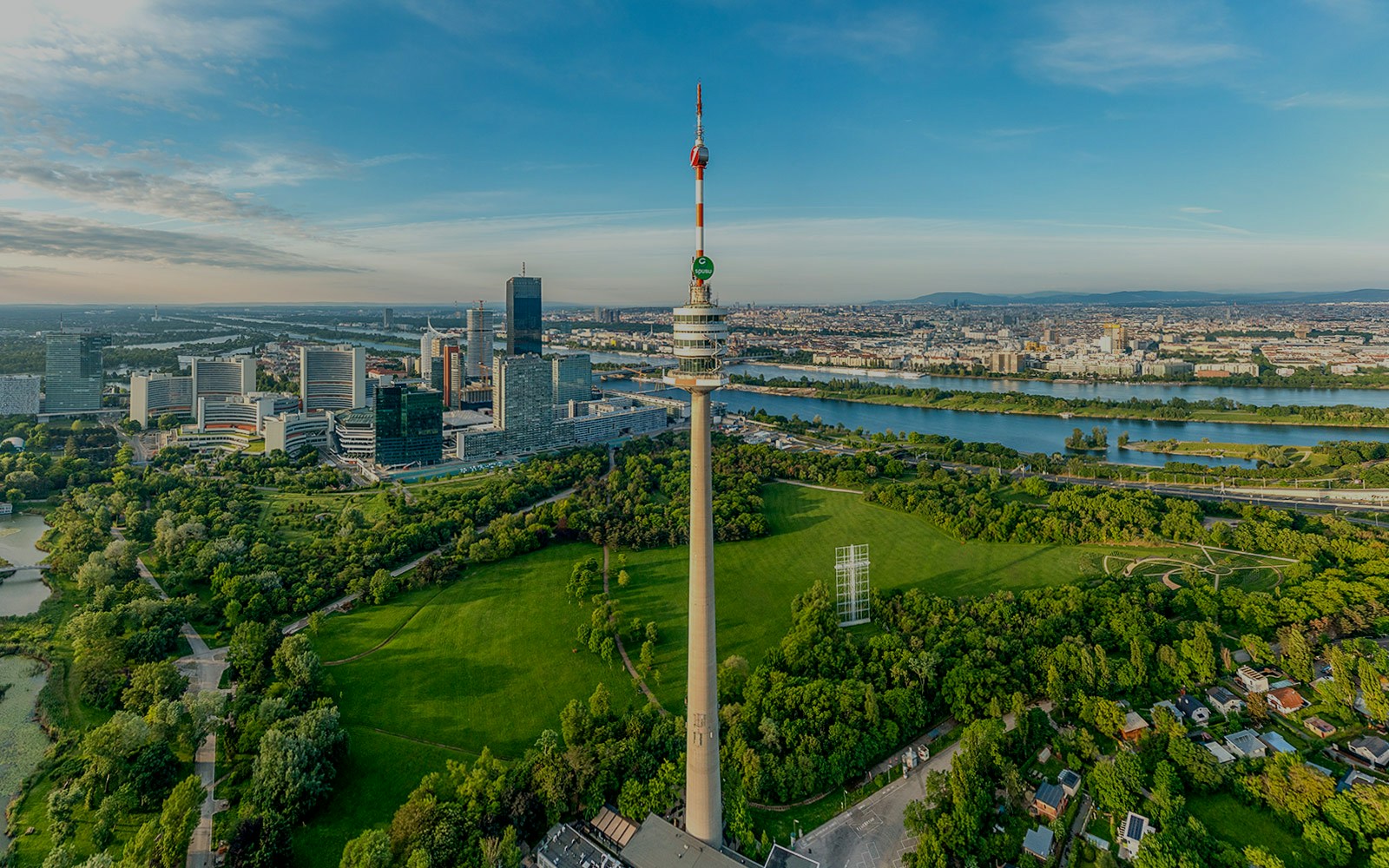 Danube Tower in Vienna with panoramic city view and lush green surroundings.