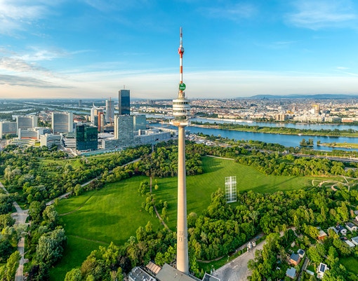 Danube Tower overlooking Vienna cityscape and green parkland, Austria.