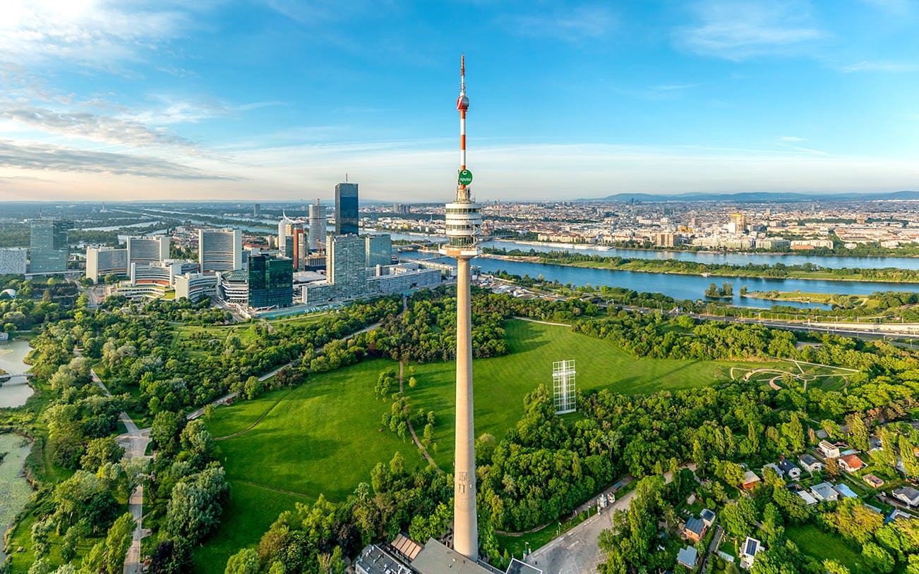 Danube Tower overlooking Vienna cityscape and green parkland, Austria.