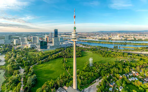 Danube Tower overlooking Vienna cityscape and green parkland, Austria.