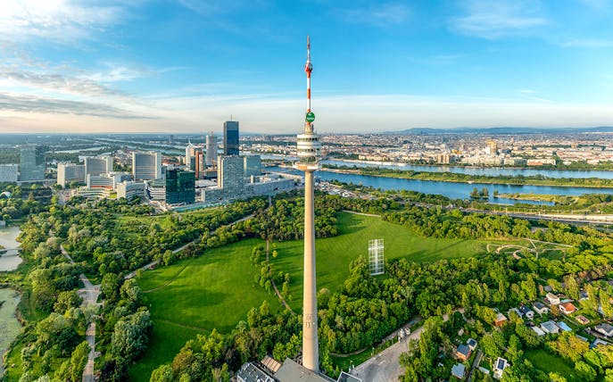 Danube Tower overlooking Vienna cityscape and green parkland, Austria.