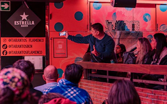 Audience at Los Tarantos Flamenco Show in Barcelona capturing the performance on a phone.