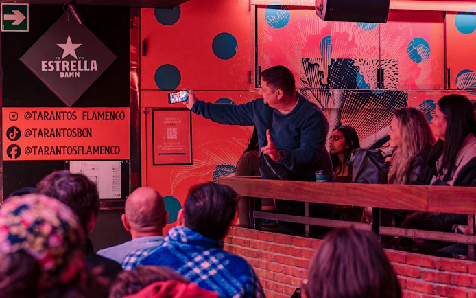 Audience at Los Tarantos Flamenco Show in Barcelona capturing the performance on a phone.