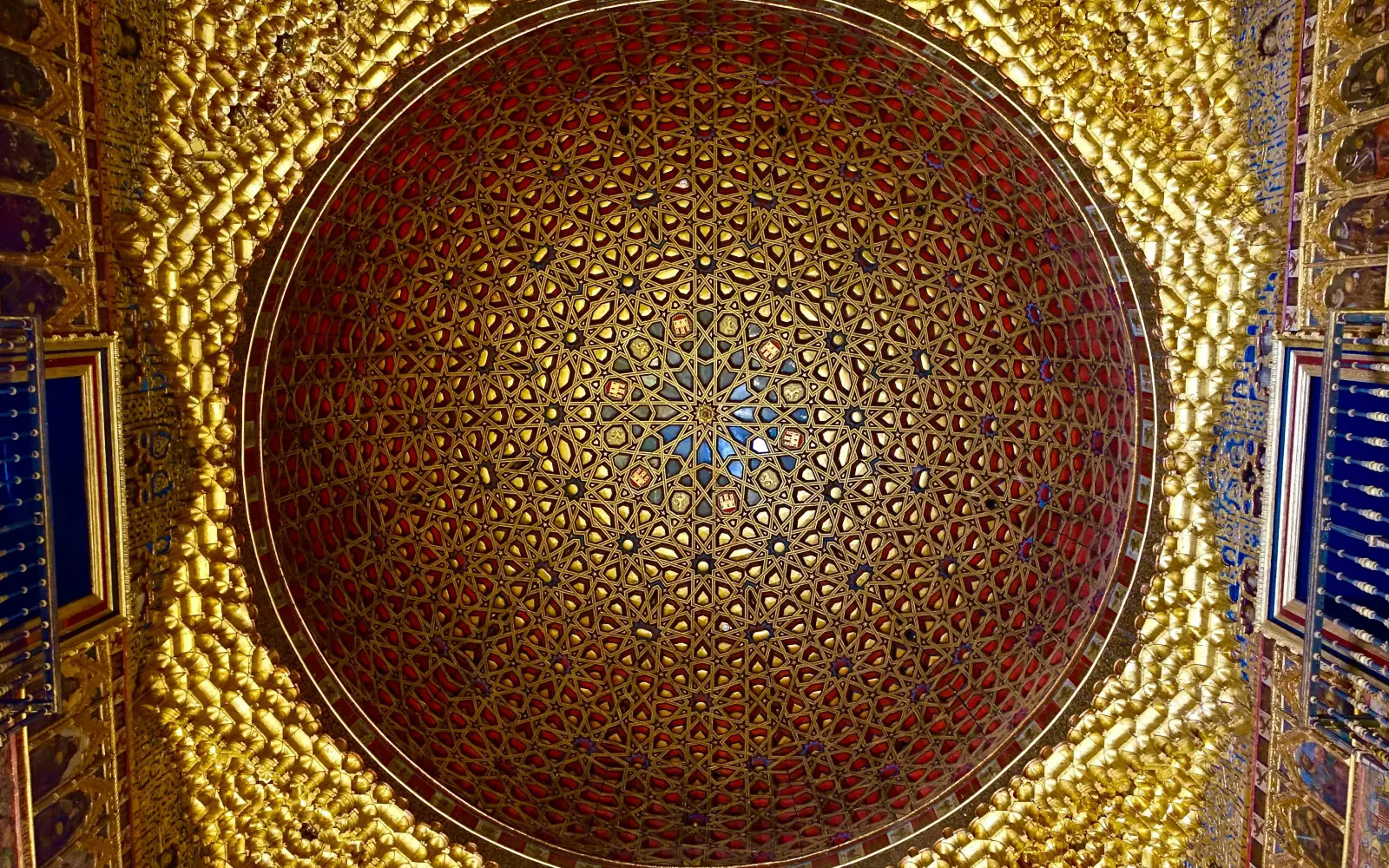 Ornate dome ceiling with intricate geometric patterns in Alcazar Seville.