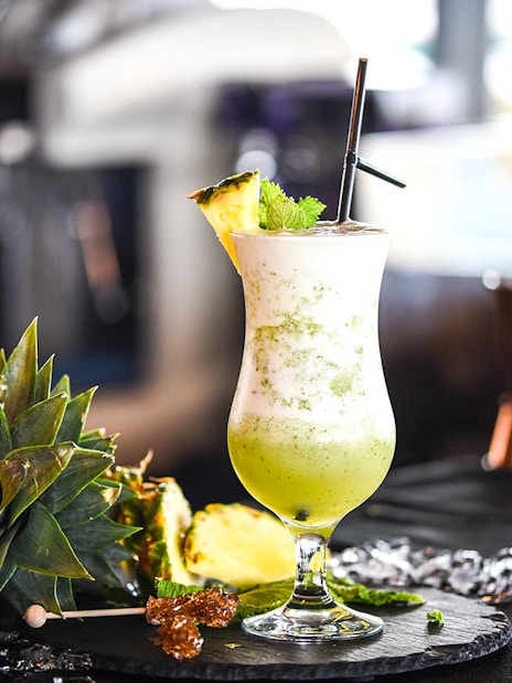 Mocktail with pineapple garnish at Burj Khalifa At the Top, Levels 124-125.