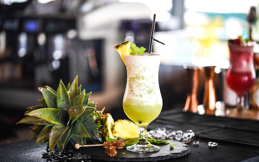 Mocktail with pineapple garnish at Burj Khalifa At the Top, Levels 124-125.