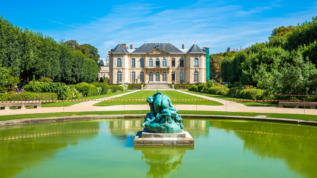 Rodin Museum garden with sculpture and historic building in Paris.