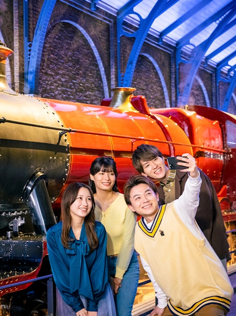 Group taking a selfie in front of Hogwarts Express at Warner Bros. Studio Tour Tokyo.