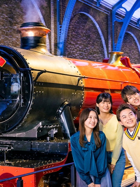 Group taking a selfie in front of Hogwarts Express at Warner Bros. Studio Tour Tokyo.