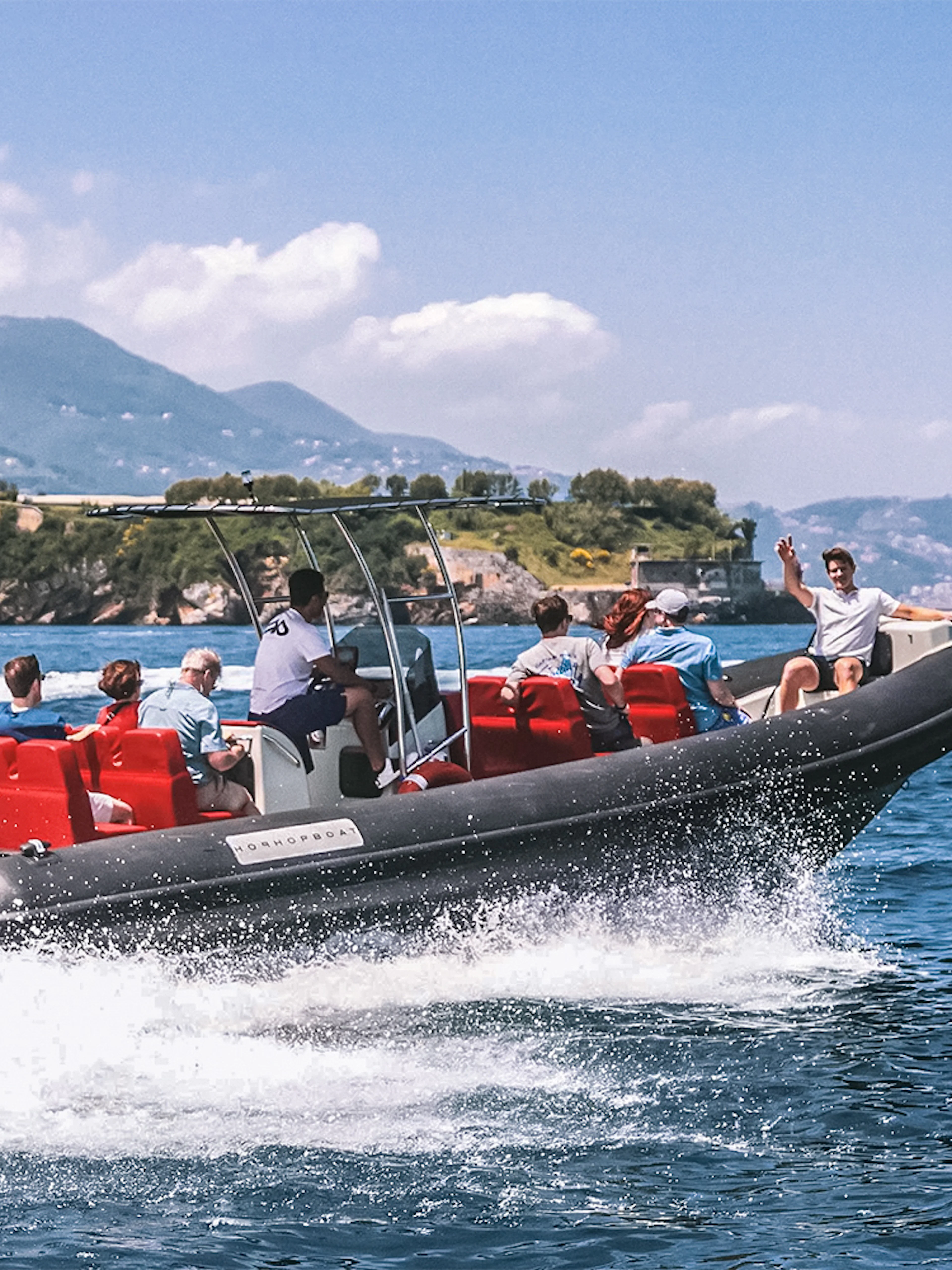 Boat tour with skipper and passengers near Cinque Terre, Italy, with coastal views.