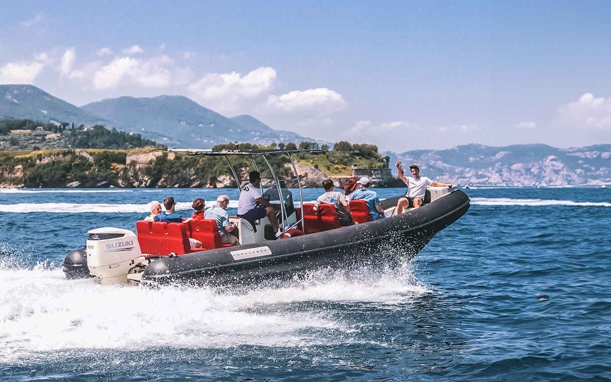 Boat tour with skipper and passengers near Cinque Terre, Italy, with coastal views.