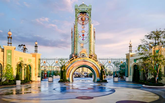 Entrance to Universal Epic Universe theme park with ornate archway and decorative elements.