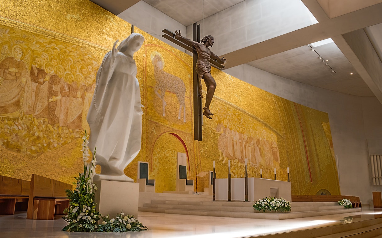 Statue of Mary and crucifix in the Basilica of the Holy Trinity, Fatima, Portugal.