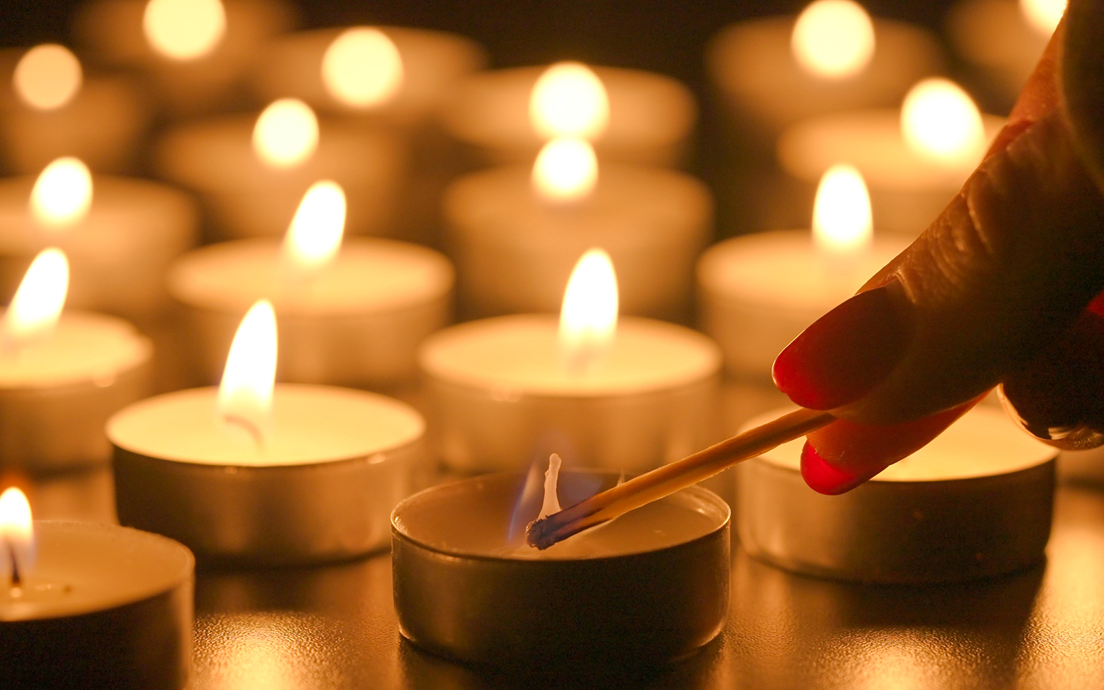 Lighting candles at Sant’Anselmo nighttime mass.