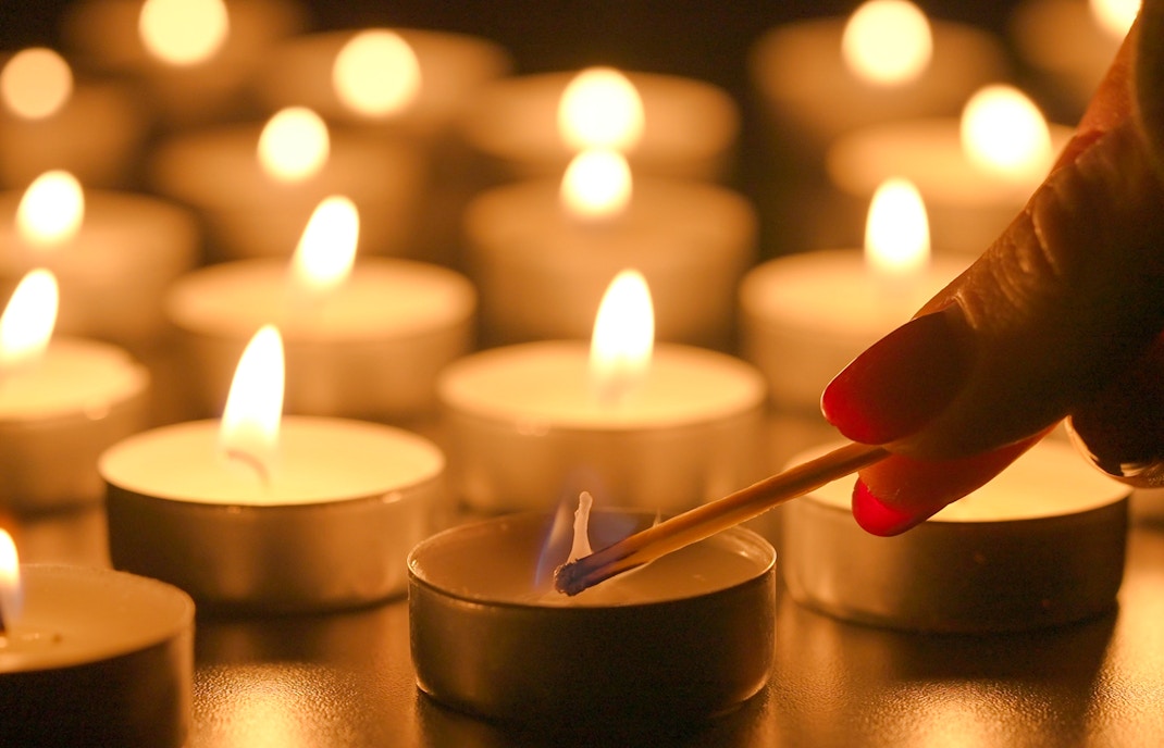 Lighting candles at Sant’Anselmo nighttime mass.