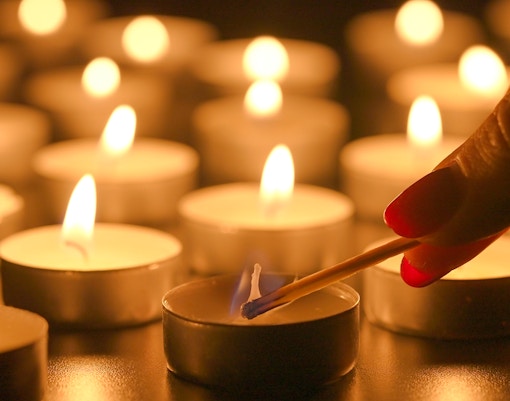 Lighting candles at Sant’Anselmo nighttime mass.